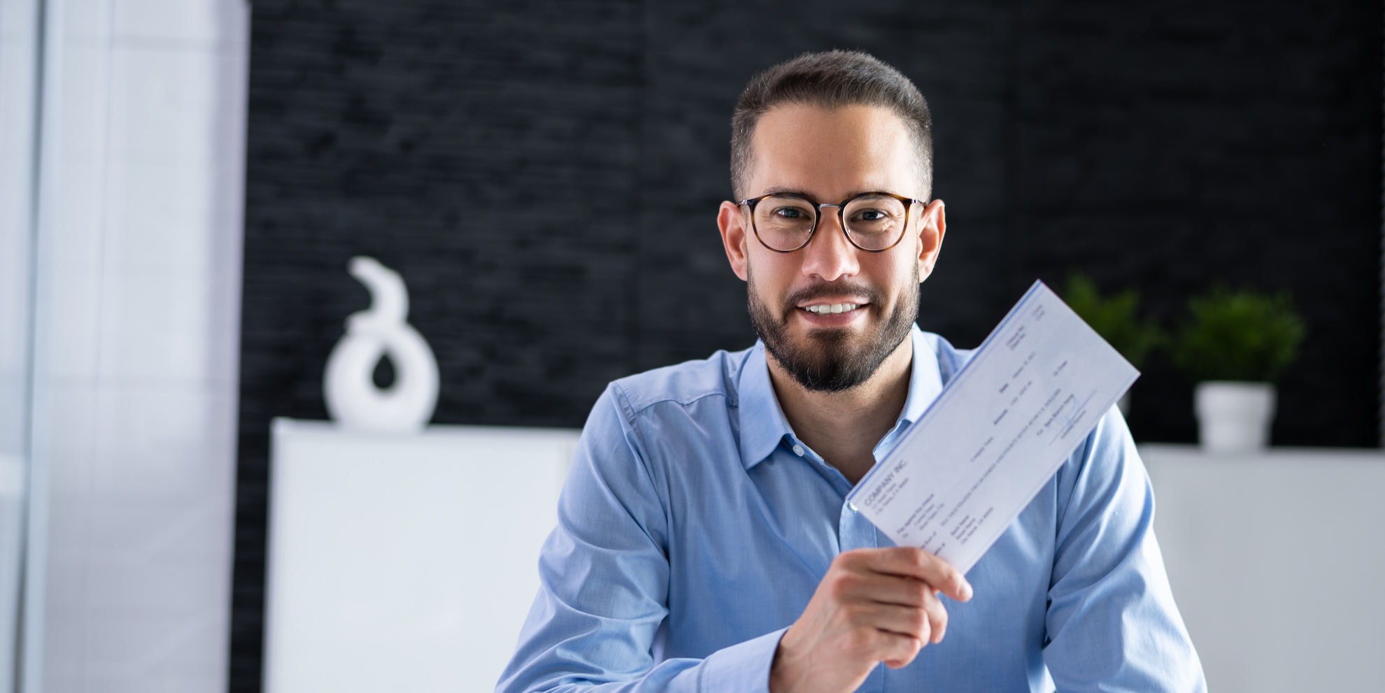Young man holding a check