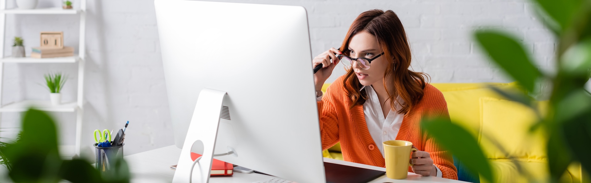 Woman sitting at desk working on computer