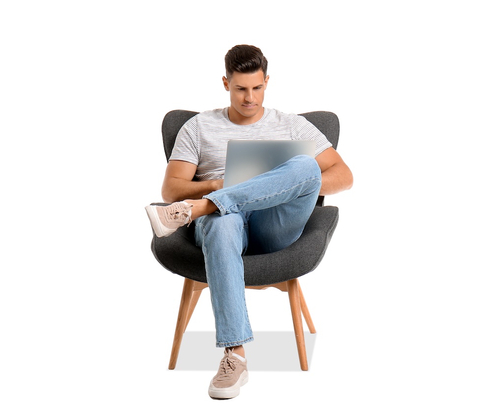 Man sitting in chaair working on laptop