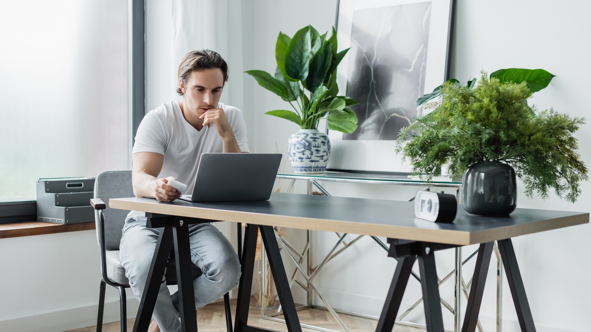 Male freelancer working on notbook computer at table